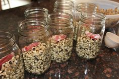 several jars filled with food sitting on top of a counter