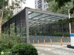 a building that has some trees in front of it and orange cones on the ground