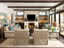 a living room filled with furniture and a flat screen tv mounted on the wall above a fireplace