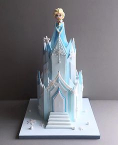 a frozen princess castle cake is on display