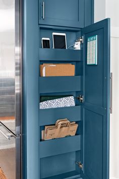 an open blue cabinet with papers and other items in it