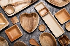 wooden spoons and plates are arranged on a table