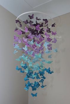 a wind chime with purple and blue butterflies hanging from it's centerpiece