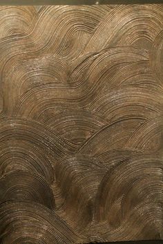 an artistic piece of wood with wavy lines on it