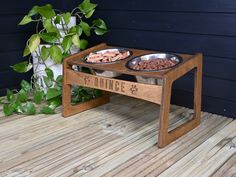 two bowls of dog food on a wooden table