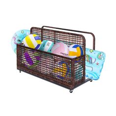 an iron basket with beach balls and toys in it on top of a white background