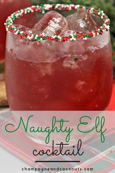 a close up of a drink in a glass with candy canes on the rim