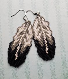 a pair of black and white beaded earrings