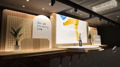 a man standing on stage in front of a large screen with the google marketing live logo