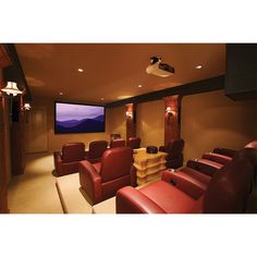 a home theater with red leather chairs and a flat screen tv mounted on the wall