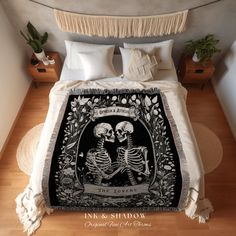 a bed covered in a blanket with two skeletons on it