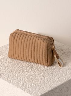 Perfect your on-the-go lifestyle with Shiraleah's Ezra Small Boxy Cosmetic Pouch. This pouch features a quilted nylon body and a boxy silhouette, perfectly matching the material throughout Shiraleah's Ezra collection. Measuring L 7" × W 3" × H 4" and equipped with an inner zip and slip pocket, this pouch is perfect for storing your makeup, toiletries or any odds and ends that you may need during travel or on a daily basis. Pair with other items from Shiraleah to complete your look! Color: Tan L Greek Gifts, Accessories Display, Odds And Ends, Diy Mirror, Monogram Styles, Small Pouches, How To Make Handbags, Toiletry Bags, Cosmetic Pouch