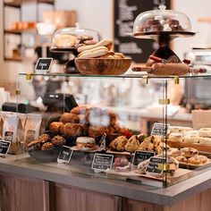 an assortment of baked goods on display in a bakery