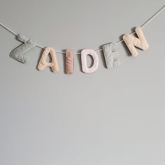 the letters made out of clay are hanging on a string