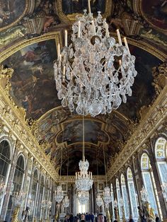 a chandelier hanging from the ceiling in a large room