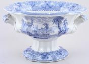 a blue and white porcelain bowl with horses on the side, in front of a white background