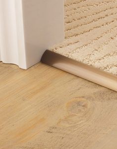 a close up view of the corner of a room with a rug on the floor