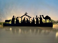 a nativity scene with the birth of jesus and three wise men in silhouettes