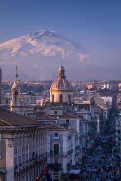 a city with tall buildings and a mountain in the background