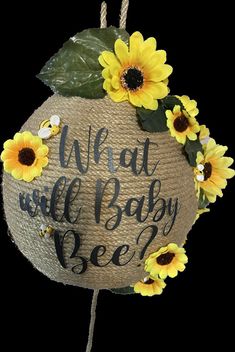 a wicker ball with sunflowers on it that says, what will baby bee?