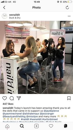 a group of women sitting at a table in front of a counter with nails on it