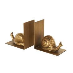 two brass bookends with snails on them