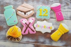 decorated cookies are laid out on a wooden table