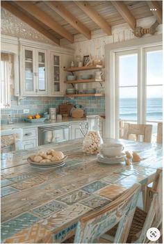 a kitchen table with plates and bowls on it