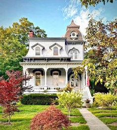 a white house in the middle of some trees