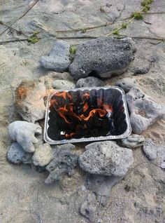 a metal container sitting on top of some rocks