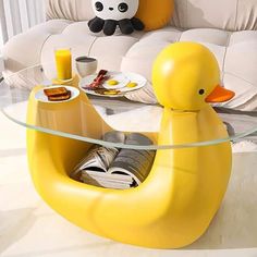 a yellow ducky shaped coffee table in the middle of a living room