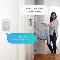 a woman standing in front of a door holding a jacket