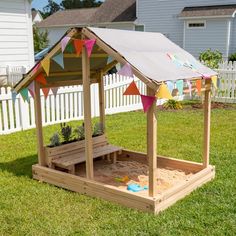 a small wooden structure with flags on it