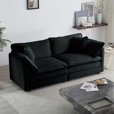 a living room with a black couch and coffee table