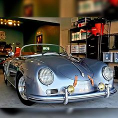 an old car is parked in a garage