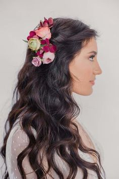 a woman with long hair and flowers in her hair