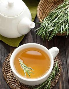 a cup of tea with rosemary on the side