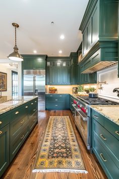 a kitchen with green cabinets and an area rug on the floor in front of the stove