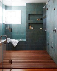 a bath room with a shower and a wooden floor