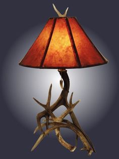 a lamp with antlers on it and a red shade