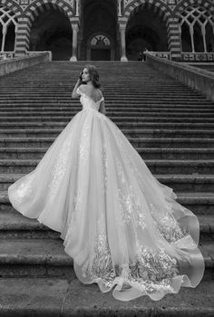 a woman in a wedding dress standing on some steps