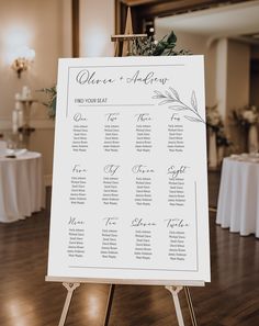 a table plan is set up on an easel in front of a banquet room