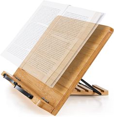 a wooden easel holding an open book on it's side with two black handles