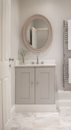 a bathroom with a sink, mirror and towel rack