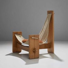 a wooden chair with a hammock attached to it's back and seat