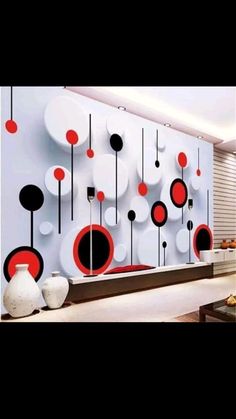 a living room filled with lots of furniture and walls covered in red and black circles