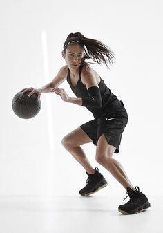 a woman holding a basketball in her right hand