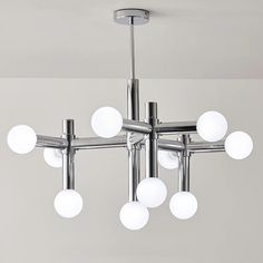 a modern chandelier with eight lights hanging from it's center point in a room