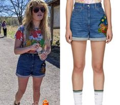 an image of a woman wearing high waisted denim shorts with patches on the side