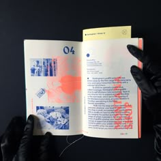 a person in black gloves holding an open book